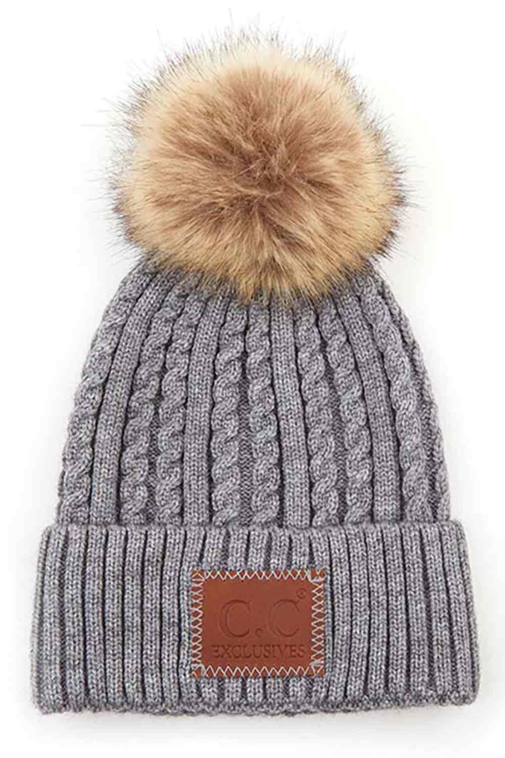 Light Grey Stay warm and stylish with the C.C Double Braided Beanie, featuring a cozy pom-pom and iconic C.C leather patch. Crafted from a durable blend of 75% acrylic and 25% nylon, this beanie offers comfort and longevity through every season.