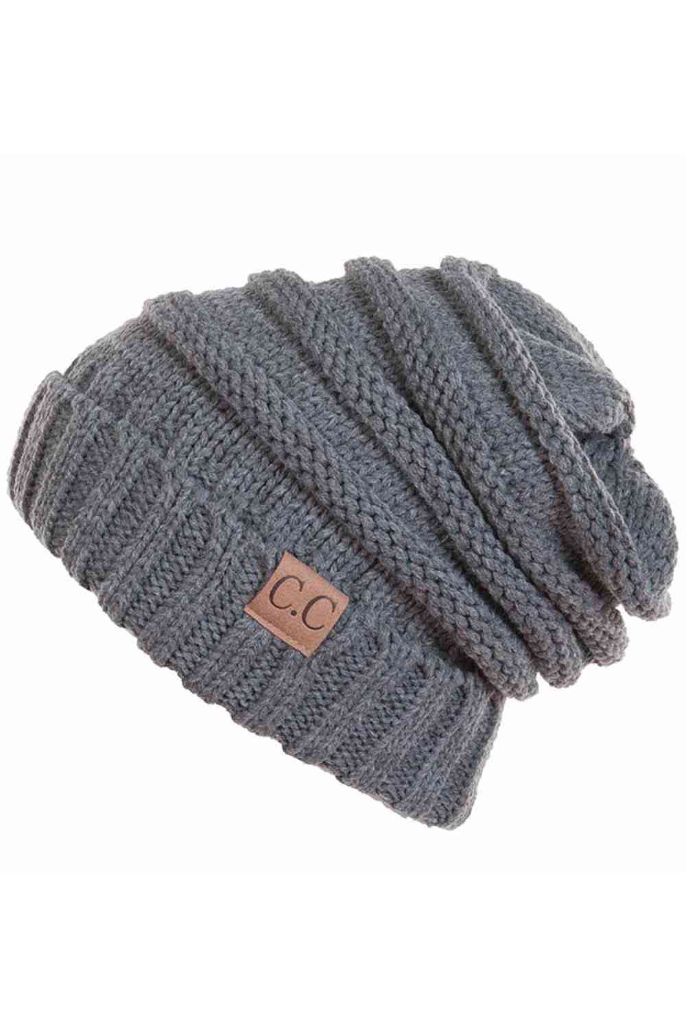 Grey Wrap yourself in warmth with this C.C Slouchy Knitted Beanie, crafted from 100% soft acrylic for ultimate comfort. The oversized silhouette and plush pom pom detail create a relaxed, on-trend look perfect for chilly days. Available in nine versatile colors—Beige, Berry, Dark Denim, Heather Gray, Ivory, Pistachio, Rose, Steel Blue, and Violet Purple—this beanie pairs effortlessly with any winter wardrobe. The ribbed knit construction ensures durability and a flattering fit. Hand wash and lay flat to dry