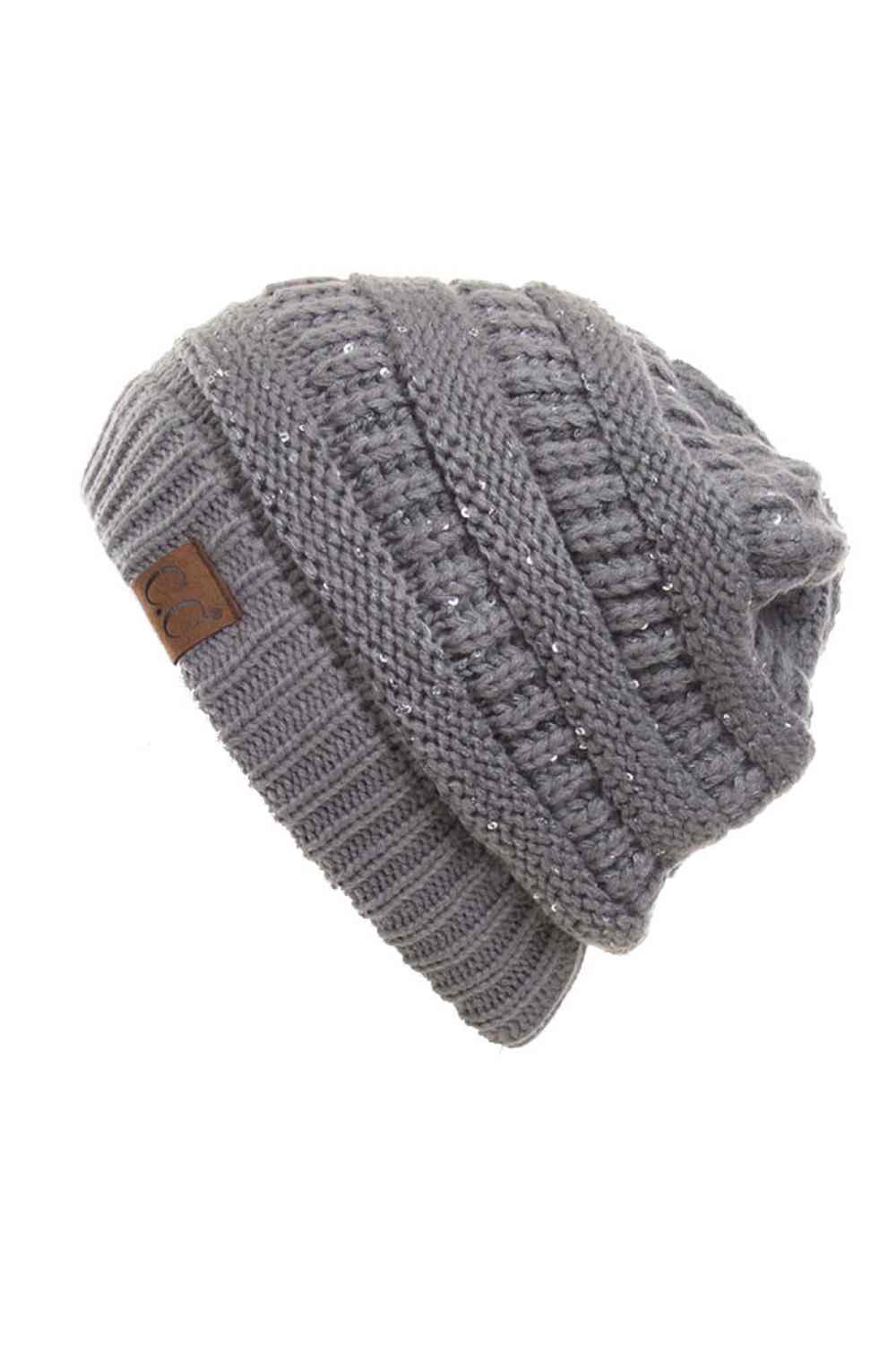 Grey C.C Sequin Ponytail Messy Bun Beanie with open top design lets you pull your hair through for a stylish, effortless look. Crafted from 100% soft acrylic, this cozy beanie keeps you warm while showcasing your ponytail or messy bun. The shimmering sequin detailing adds sparkle and dimension to your winter style. Perfect for casual days, outdoor activities, or layering under jackets. One size fits most for comfortable, versatile wear that works with any outfit.