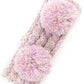 Lilac Cozy two-tone kids head wrap featuring a soft fuzzy lining for extra warmth and comfort. Double pom-pom design adds playful style perfect for cold weather. Crafted from 100% acrylic for durability and easy care. One size fits most children. A practical accessory that keeps little ones warm while looking adorable.
