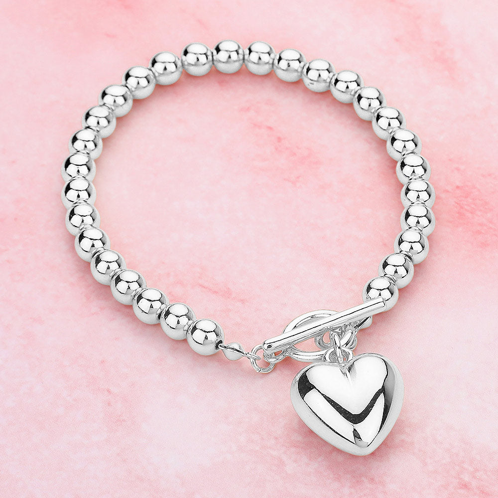 Metal Heart Charm Bubble Chain Toggle Bracelet is the perfect accessory for any outfit. The metal heart charm adds a touch of elegance, while the unique bubble chain and toggle closure provide a secure fit. Made with high-quality materials, this bracelet is both fashionable and functional, making it a must-have for any fashion-forward individual.