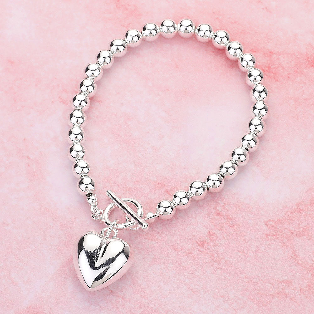 Metal Heart Charm Bubble Chain Toggle Bracelet is the perfect accessory for any outfit. The metal heart charm adds a touch of elegance, while the unique bubble chain and toggle closure provide a secure fit. Made with high-quality materials, this bracelet is both fashionable and functional, making it a must-have for any fashion-forward individual.