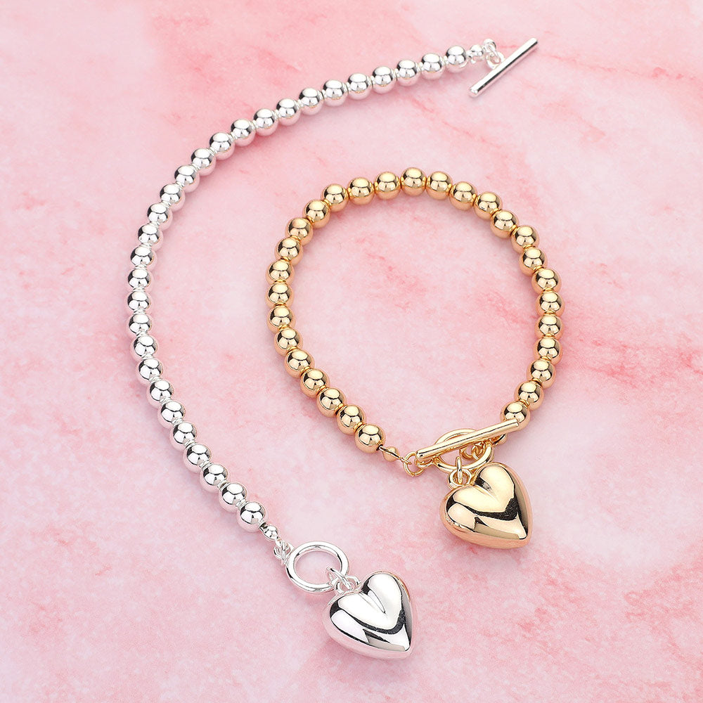 Metal Heart Charm Bubble Chain Toggle Bracelet is the perfect accessory for any outfit. The metal heart charm adds a touch of elegance, while the unique bubble chain and toggle closure provide a secure fit. Made with high-quality materials, this bracelet is both fashionable and functional, making it a must-have for any fashion-forward individual.