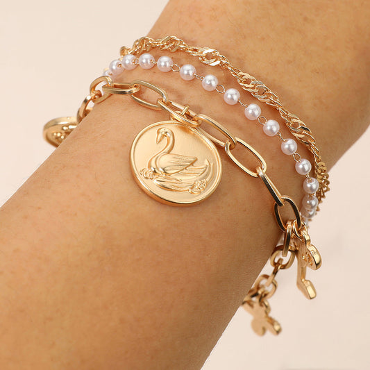 Madeline Love Cream, Matte gold 3PCS - Flower Swan Embossed Medallion Key Cross Pearl Charm Station Multi Layered Bracelets