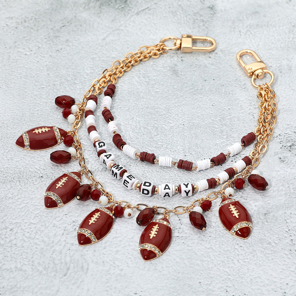 Madeline Love Burgundy, Gold, White Football Charm Embellished GAME DAY Heishi Beaded Layered Bag Charm - Bags & Wallets