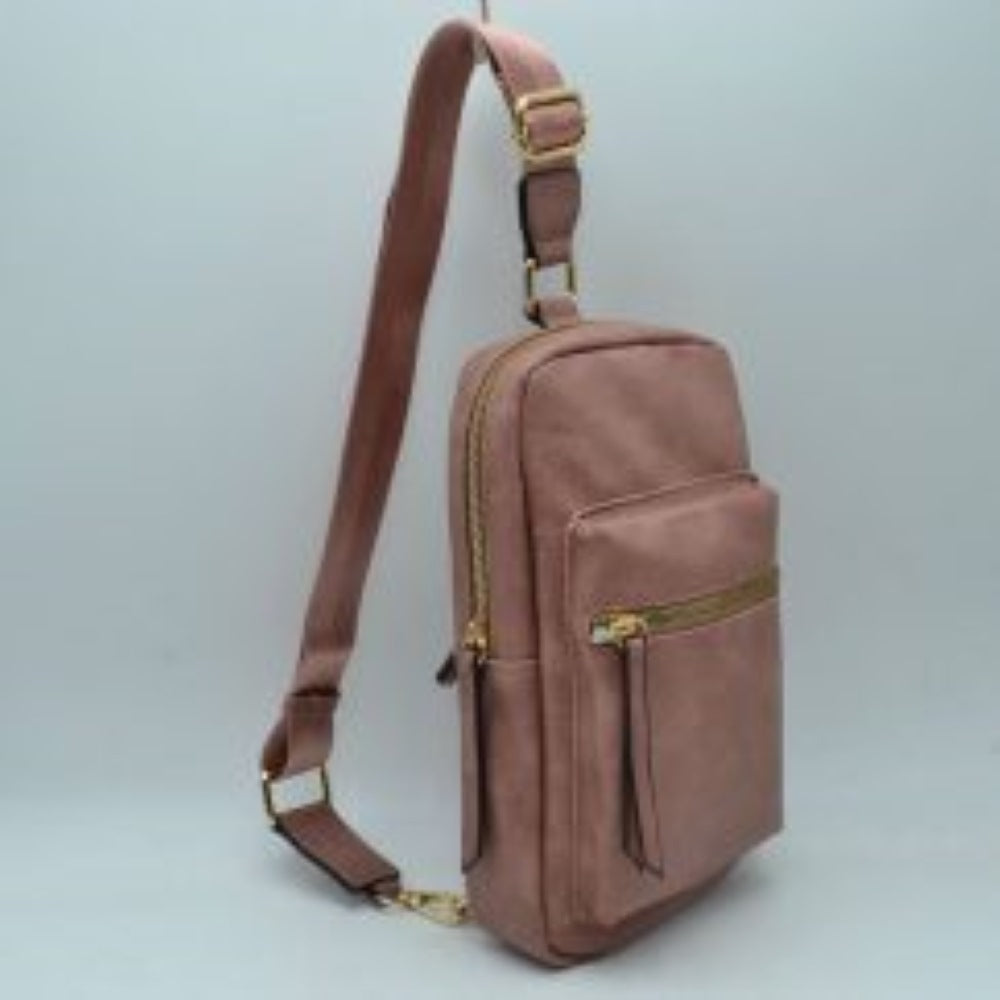 Magenta This functional sling bag features a textured, grained finish exterior designed for streamlined everyday use. It offers multiple practical storage compartments, including a curved main section secured by a prominent metallic zipper track and a secondary front pocket with a horizontal zipper and an elongated pull tab. The bag is equipped with a single wide shoulder strap that attaches via a rectangular loop and incorporates an adjustable metallic buckle to easily customize the carrying length.