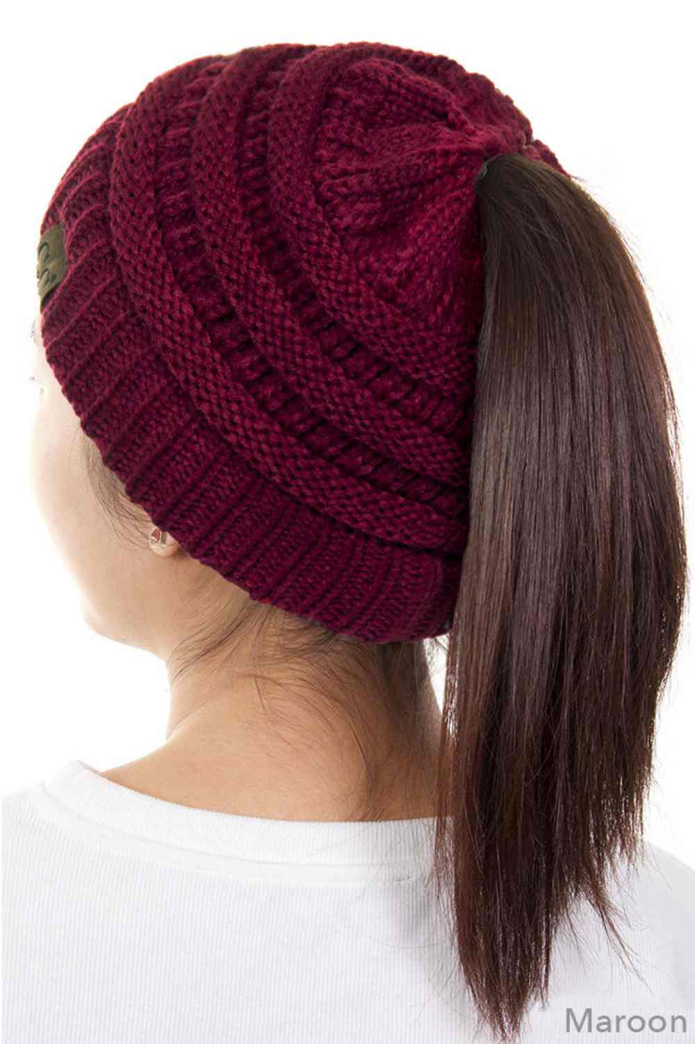 Maroon The C.C Solid Color Ponytail Messy Bun Beanie combines comfort with versatility for effortless everyday style. Crafted from 100% soft acrylic, this beanie features an open crown design that accommodates ponytails and messy buns while keeping you warm. The one-size-fits-most construction ensures a secure, flattering fit for virtually anyone. Perfect for casual outings, workouts, or relaxed weekends, this practical accessory transitions seamlessly from season to season.