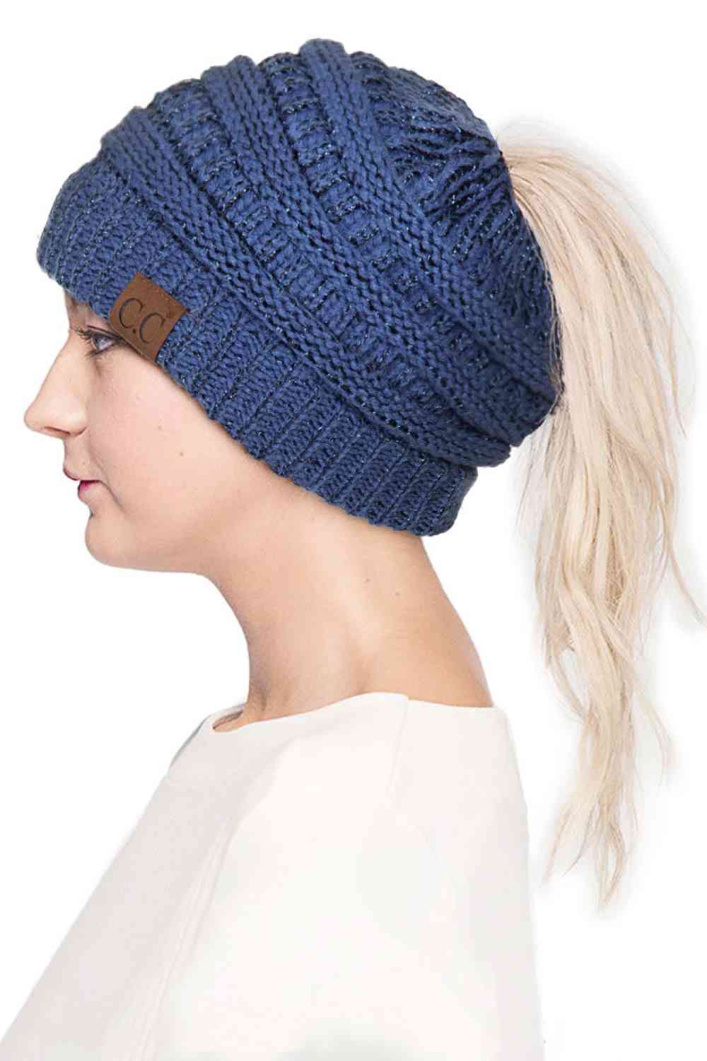 Dark Denim Stay cozy and stylish with the C.C Metallic Messy Bun Ponytail Beanie, designed for effortless everyday wear. Crafted from 100% acrylic, this lightweight beanie features a sleek metallic finish that adds a modern touch to any outfit.