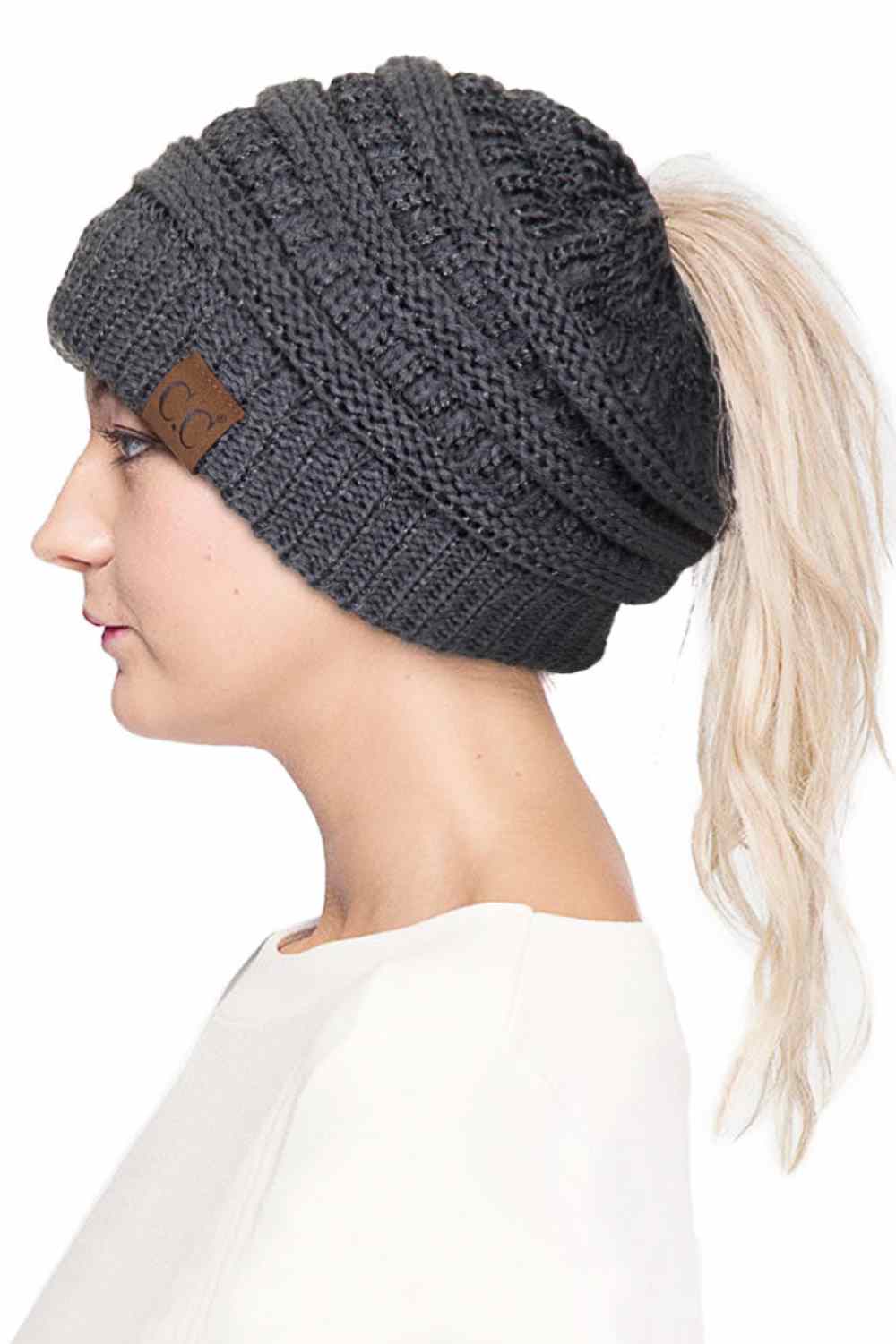 Dark Grey Stay cozy and stylish with the C.C Metallic Messy Bun Ponytail Beanie, designed for effortless everyday wear. Crafted from 100% acrylic, this lightweight beanie features a sleek metallic finish that adds a modern touch to any outfit.