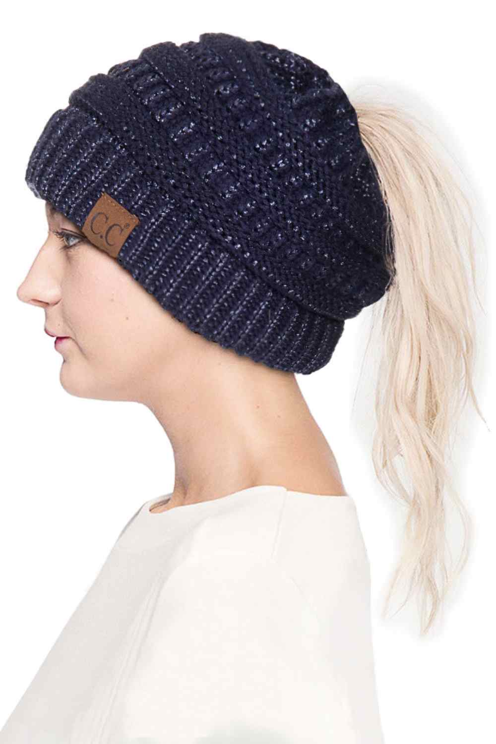 Navy Stay cozy and stylish with the C.C Metallic Messy Bun Ponytail Beanie, designed for effortless everyday wear. Crafted from 100% acrylic, this lightweight beanie features a sleek metallic finish that adds a modern touch to any outfit.