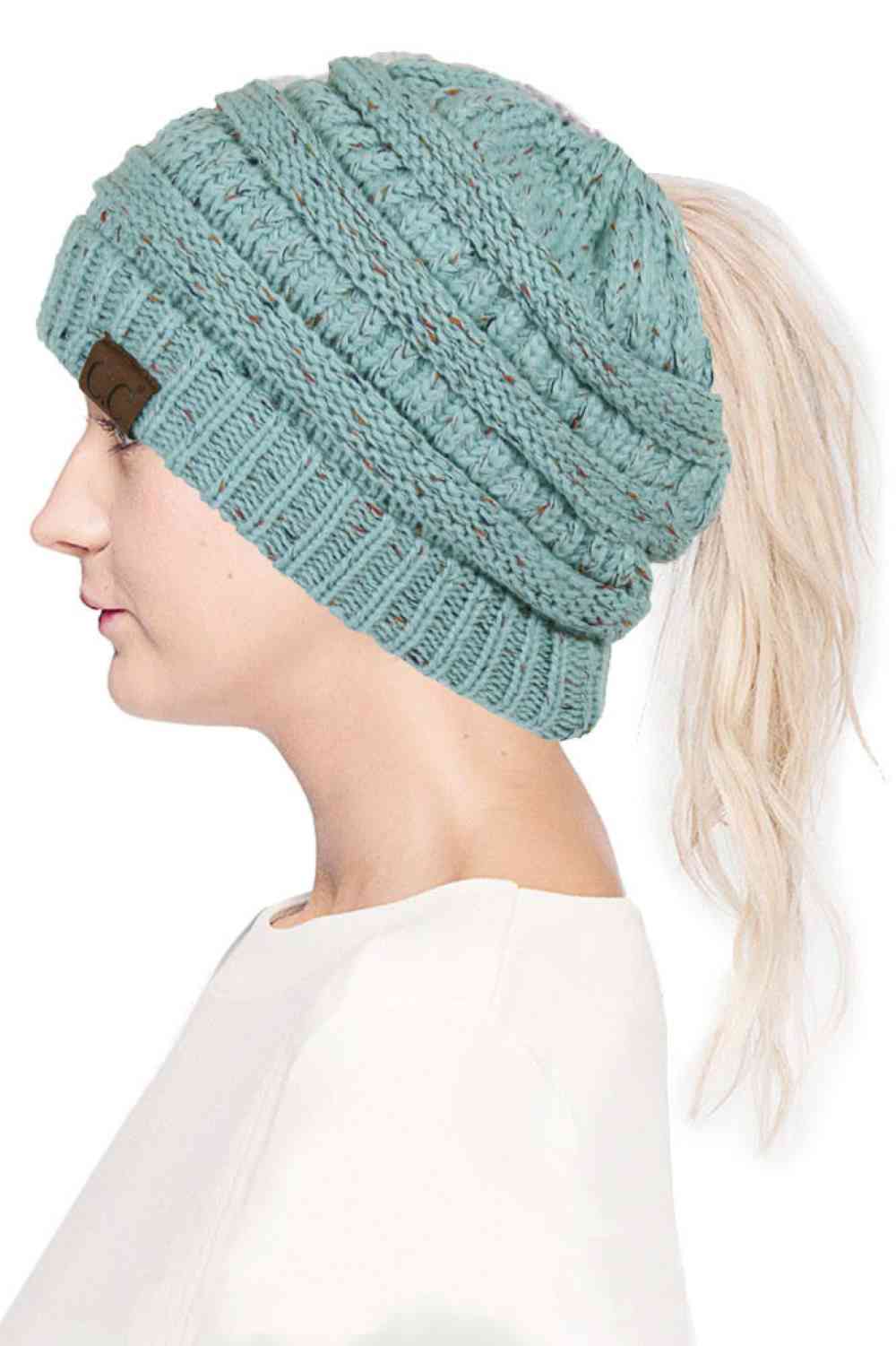 Mint The C.C Confetti Ponytail Messy Bun Beanie features a soft knit design with subtle confetti flecks for a fun, playful look. Designed with a convenient opening for ponytails or messy buns, it keeps you warm while allowing you to style your hair comfortably.