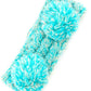 Mint Cozy two-tone kids head wrap featuring a soft fuzzy lining for extra warmth and comfort. Double pom-pom design adds playful style perfect for cold weather. Crafted from 100% acrylic for durability and easy care. One size fits most children. A practical accessory that keeps little ones warm while looking adorable.