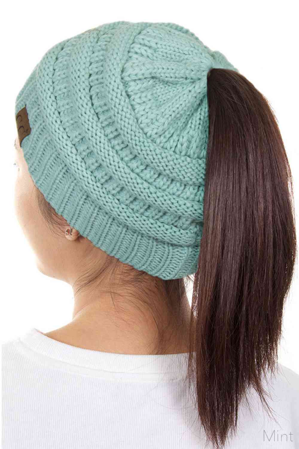 Mint The C.C Solid Color Ponytail Messy Bun Beanie combines comfort with versatility for effortless everyday style. Crafted from 100% soft acrylic, this beanie features an open crown design that accommodates ponytails and messy buns while keeping you warm. The one-size-fits-most construction ensures a secure, flattering fit for virtually anyone. Perfect for casual outings, workouts, or relaxed weekends, this practical accessory transitions seamlessly from season to season.