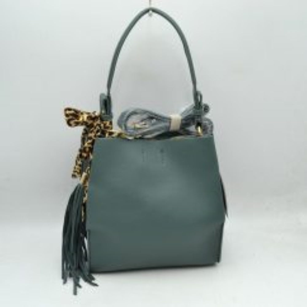 Moss This structured shoulder bag features a clean, classic silhouette with a finely textured dark brown exterior, making it a stylish choice for everyday versatility. The design is detailed with an integrated top shoulder strap secured by polished gold-tone side rings. It stands out with a decorative, silky leopard-print scarf tied around one of the strap loops, complemented by a cascading long fringe tassel on the side for added movement and texture.