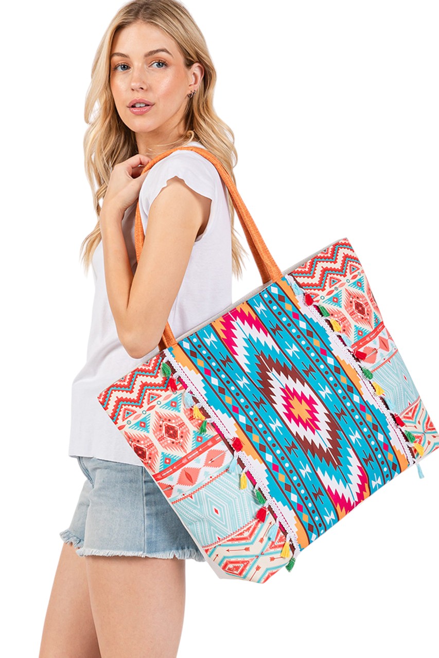 Multi Boho Style Aztec Pattern Tassel Summer Tote Bag combines vibrant cultural design with practical functionality. Featuring a distinctive Aztec pattern and decorative tassels, it offers spacious storage ideal for summer outings, beach trips, or everyday use. Crafted from durable materials, this tote ensures longevity while adding a stylish, artisanal touch to your wardrobe. Ideal for those seeking a blend of distinctive aesthetics and dependable functionality in their accessories. 