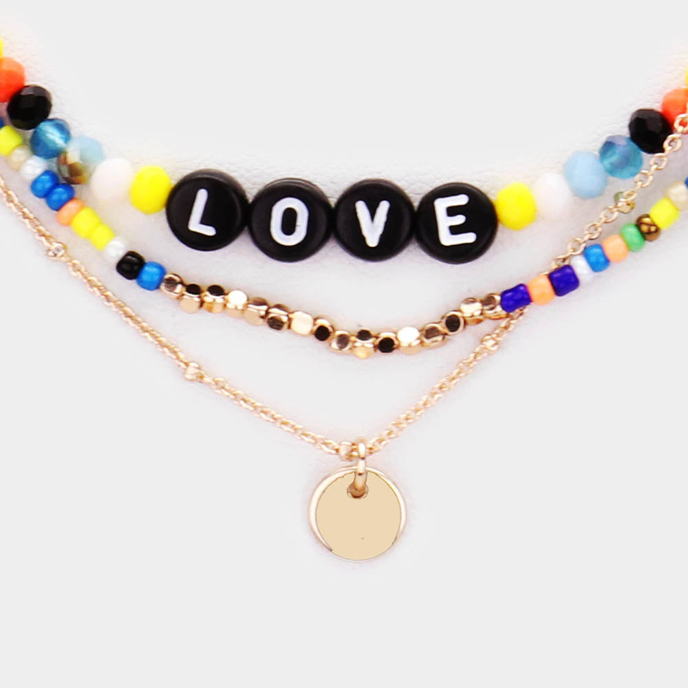 Multi-Color Bead Statement Love Layered Necklace is the perfect accessory to add a touch of fun and color to any outfit. The layered design adds depth and dimension, while the eclectic mix of beads creates a unique, eye-catching look. Elevate your style with this love-inspired necklace.