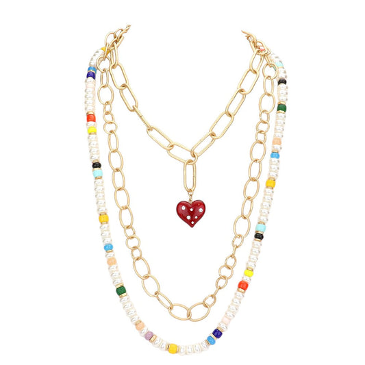 Multi Heart Pendant Accented Pearl Resin Beaded Triple Layered Necklace adds a touch of elegance and sophistication to any outfit. The heart pendant adds a sentimental touch, while the layered design creates a bold and eye-catching look. Made with high-quality materials, this necklace is both beautiful and durable.