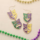 Glittered Enamel Mardi Gras Mask Link Dropdown Dangle Earrings add a touch of festive charm to any outfit. Crafted with vibrant colors and intricate designs, these earrings are perfect for Mardi Gras celebrations or themed events. The glittered enamel offers a playful sparkle, while the dropdown design adds movement and flair to your look. Elevate your style with these unique and eye-catching earrings. 