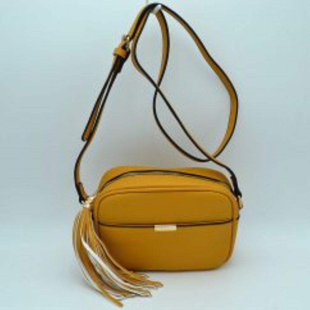 Mustard This sophisticated crossbody bag features a structured camera-bag silhouette crafted from a textured pebbled faux leather in a neutral beige tone, making it a versatile addition to any wardrobe. The clean-lined front is detailed with a subtle open slip pocket highlighted by a polished, gold-tone metal hardware accent at the center. Secured by a smooth top-zipper closure, the bag is finished with an adjustable shoulder strap and a dramatic