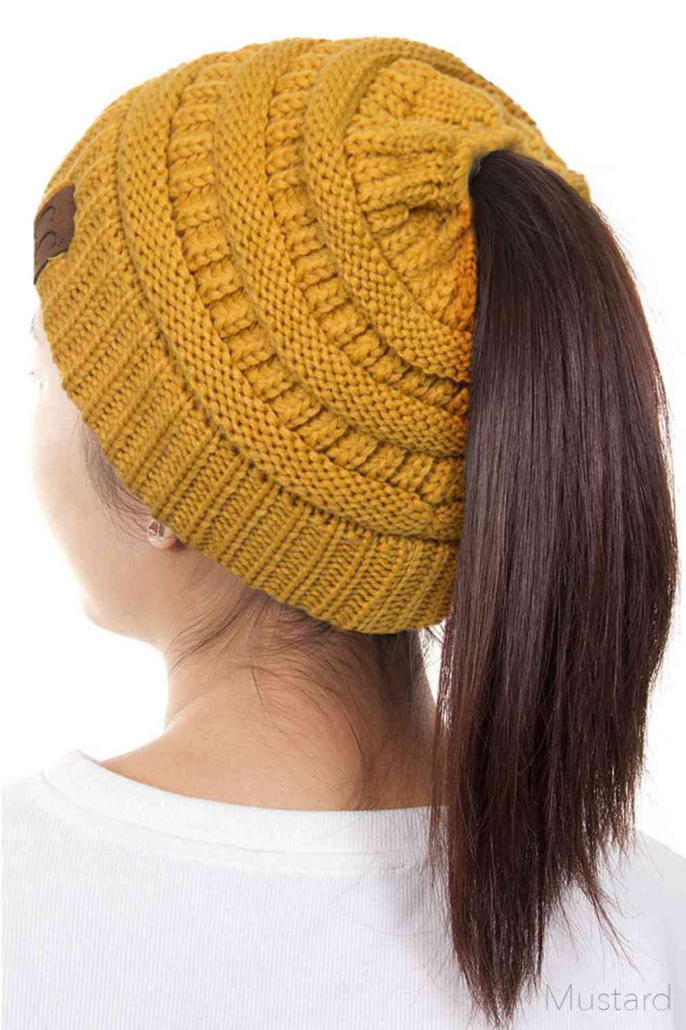 Mustard The C.C Solid Color Ponytail Messy Bun Beanie combines comfort with versatility for effortless everyday style. Crafted from 100% soft acrylic, this beanie features an open crown design that accommodates ponytails and messy buns while keeping you warm. The one-size-fits-most construction ensures a secure, flattering fit for virtually anyone. Perfect for casual outings, workouts, or relaxed weekends, this practical accessory transitions seamlessly from season to season.