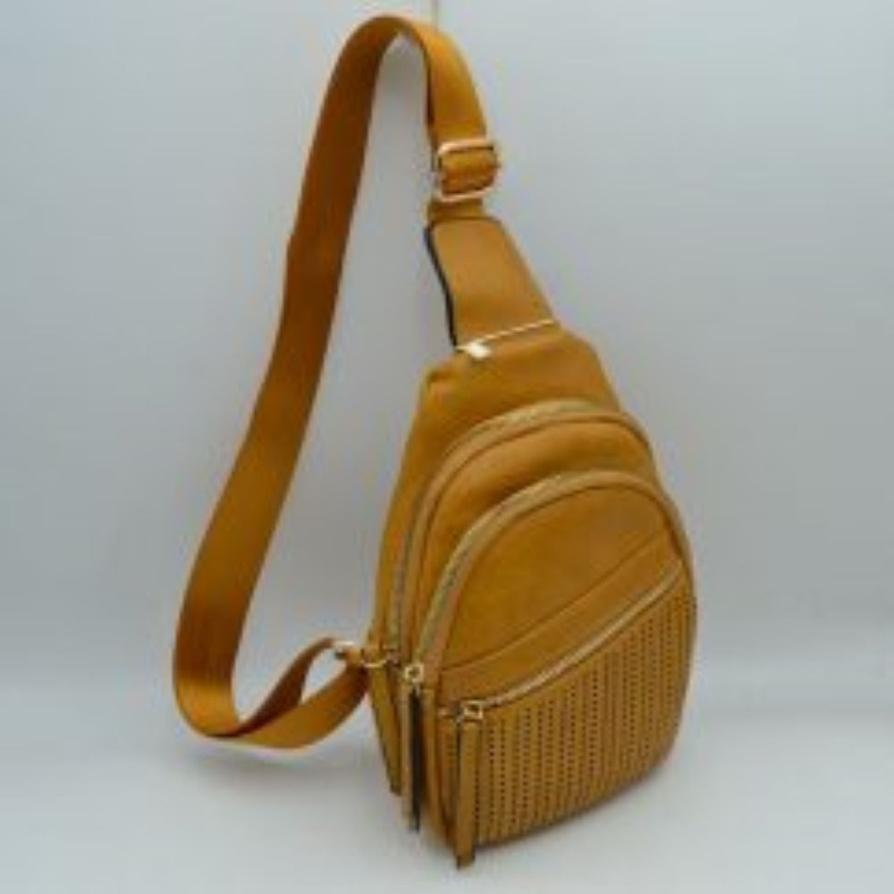 Mustard This functional sling bag features a textured, grained finish with a multi-tiered silhouette engineered for organized everyday use. It provides multiple distinct storage compartments, including a primary curved main section, an intermediate arched pouch, and a lower pocket featuring a horizontal zipper closure and a decorative perforated design. The bag is completed by a single wide