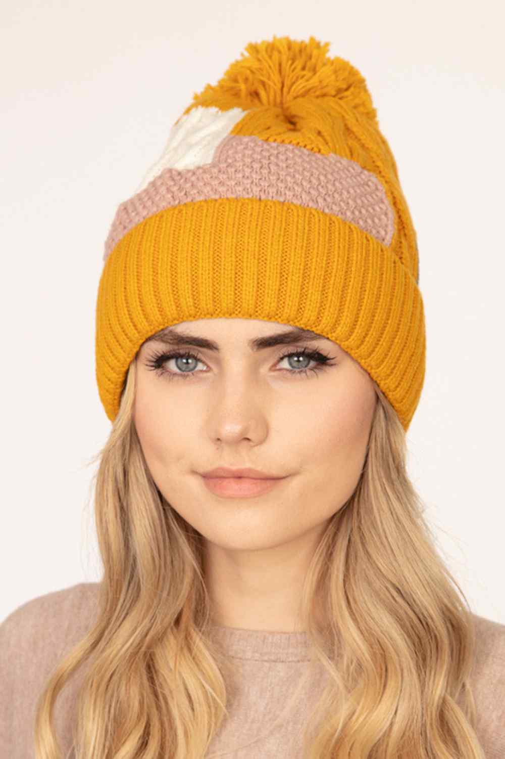 Mustard Stay warm and stylish with this patch fleece pom beanie, crafted from 100% acrylic for softness and durability. The fuzzy fleece construction provides cozy comfort during cold weather, while the oversized pom pom adds a fun, playful element.