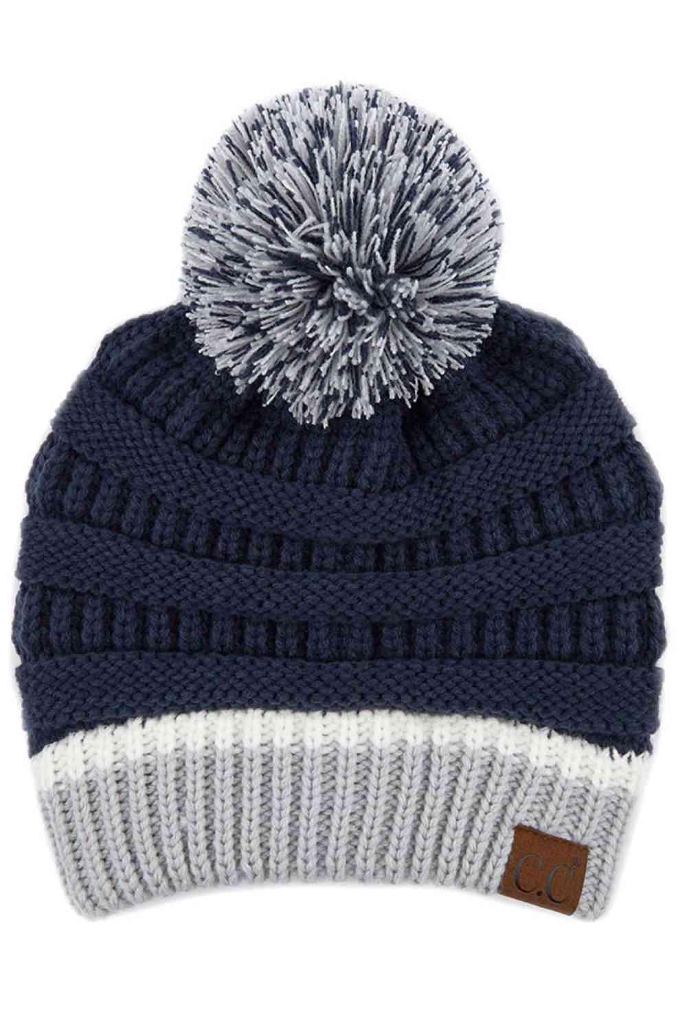 Navy SIlver The C.C Team Color Ribbed Beanie combines style and comfort in one versatile piece. Crafted from 100% acrylic, this beanie features a classic ribbed knit design with a playful pom on top, making it perfect for staying warm during chilly days.
