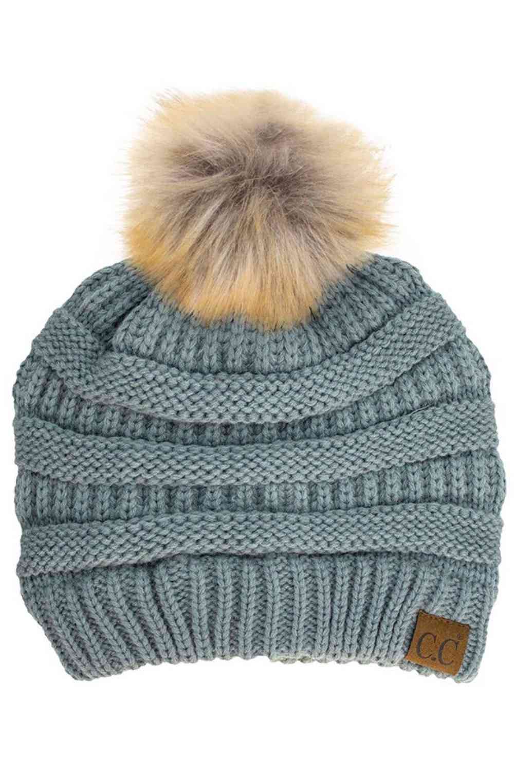 Natural Gray Stay warm and cozy with this classic C.C Pom Pom Knit Beanie, crafted from 100% soft acrylic for all-day comfort. The ribbed knit design adds texture and durability, while the signature pom pom on top brings a playful touch to any winter outfit. One size fits most, making it the perfect accessory for everyone. Ideal for cold weather adventures or casual everyday wear.