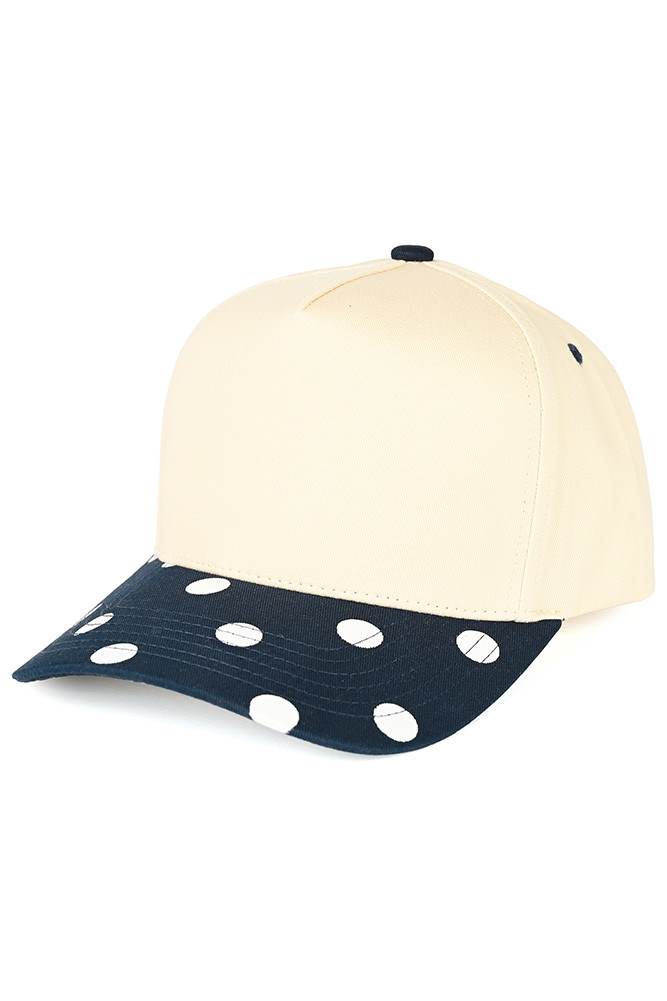 Classic style meets playful design with this C.C trucker hat. Bold big polka dots print the brim while two-tone construction adds visual interest and versatility. Structured mesh panels keep you cool and comfortable all day long, whether you're at the beach, running errands, or enjoying outdoor activities. The adjustable back strap ensures a secure, customizable fit for most head sizes. Fun, functional, and effortlessly stylish. Available Colors: Black, Brown, Navy, Red, White 100% Cotton Circumference: 22.