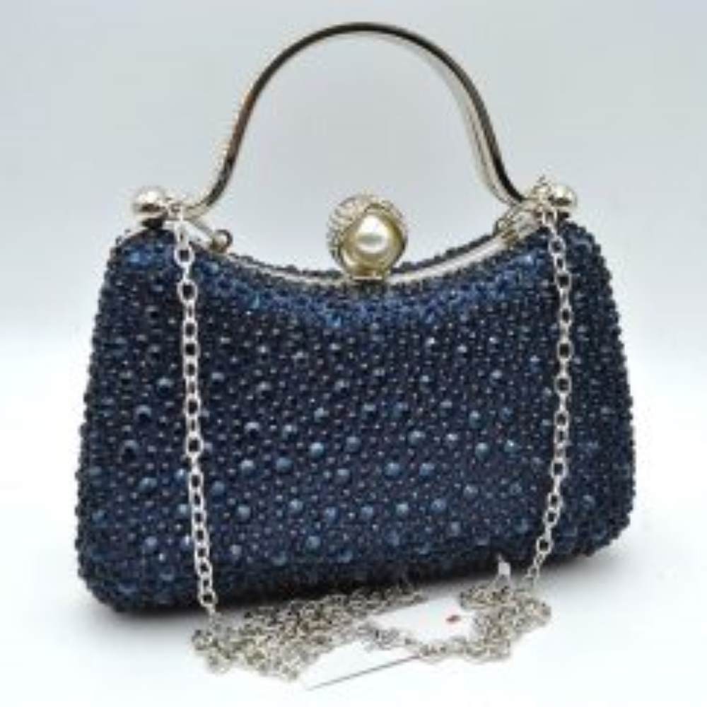 Navy-blue This elegant evening clutch bag features a structured silhouette heavily encrusted with shimmering black rhinestones, offering a highly textured and glamorous look for formal events. A sleek, curved metallic top handle lined with delicate crystals rises over the frame for a secure grip, anchored by polished spherical accents. The secure metal frame is highlighted by a prominent decorative clasp featuring a large faux pearl wrapped in rhinestone-studded detailing