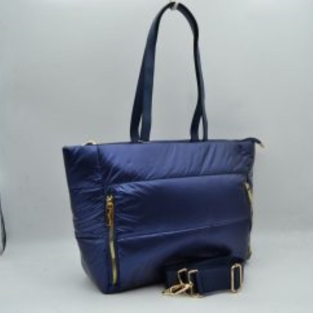 Navy-blue This versatile tote bag features a modern puffer design with horizontal quilted panels and a sleek satin-like finish, making it a stylish choice for everyday organization. It is equipped with dual flat shoulder handles for comfortable carrying, alongside a secondary adjustable fabric crossbody strap attached with metallic gold-tone hardware. The main storage compartment secures with a full top zipper closure
