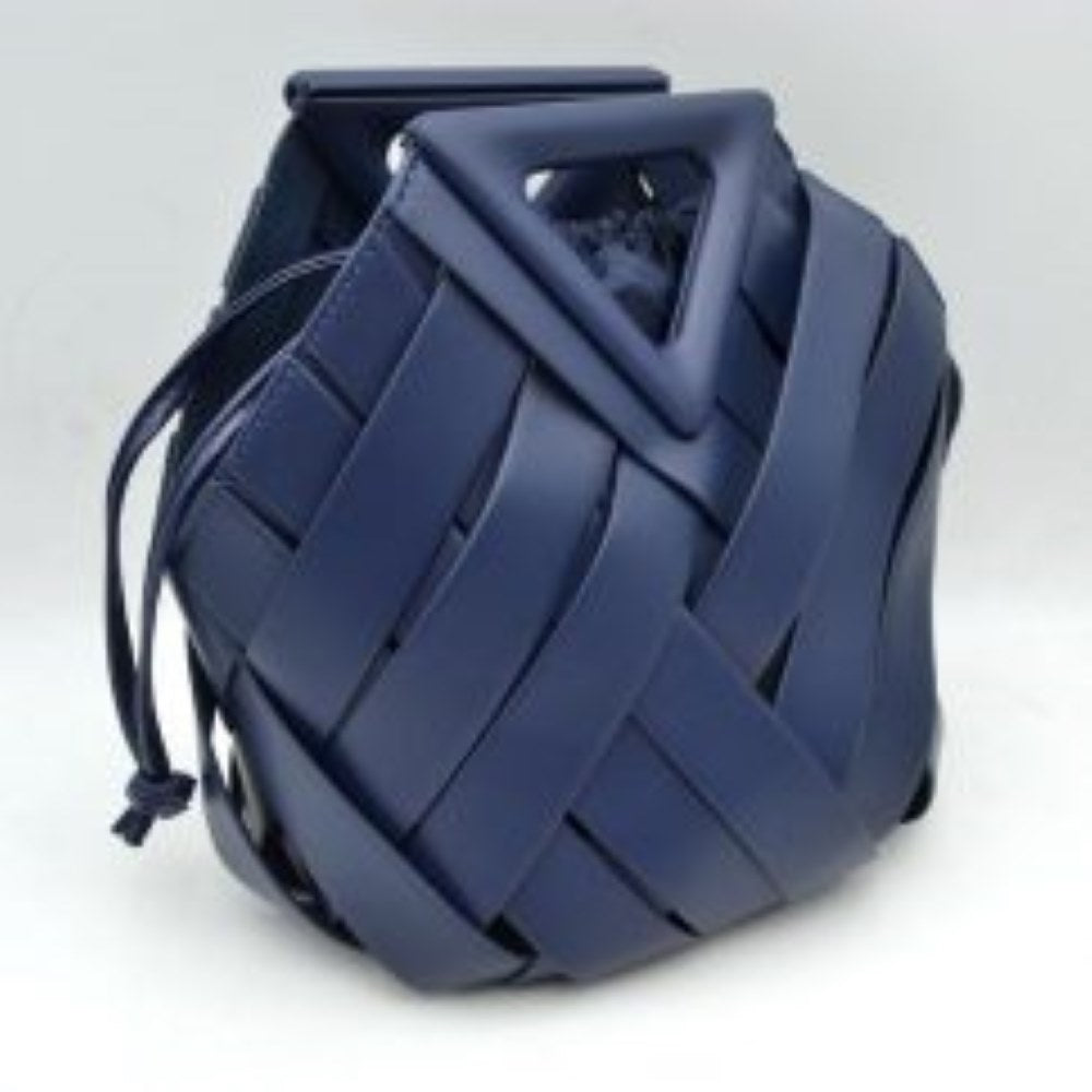 Navy-blue This structural bucket bag features a distinctive geometric design composed of overlapping wide woven straps that create an eye-catching pattern, making it a unique statement piece for everyday use. A rigid triangular cutout shape forms an integrated top handle, while an additional long, flat shoulder strap extends from the upper frame for comfortable over-the-shoulder carrying.