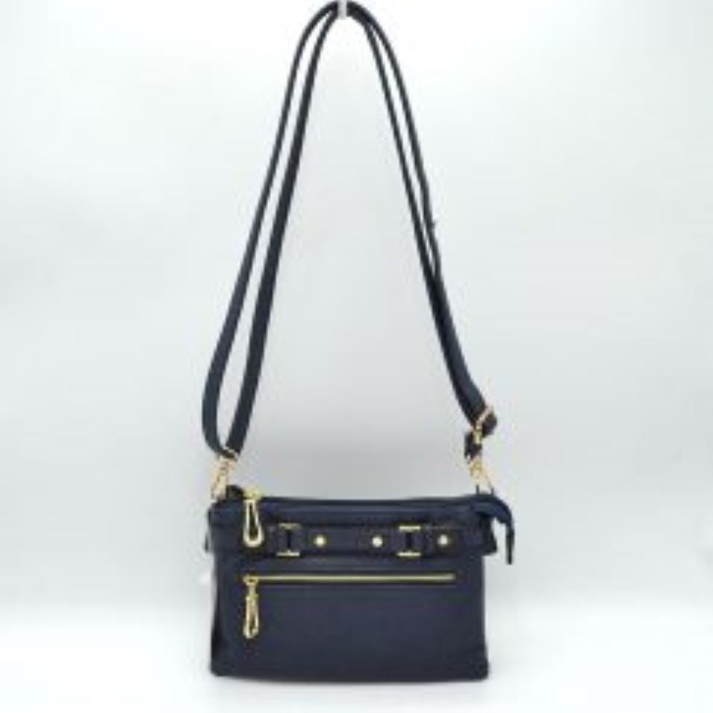 Navy Blue This functional crossbody bag is designed for organized everyday use, featuring a textured exterior equipped with multiple secure storage compartments. The front panel includes a convenient horizontal zippered pocket accented with an oversized metallic zipper pull, situated beneath a decorative horizontal band detailed with metallic studs and loops.