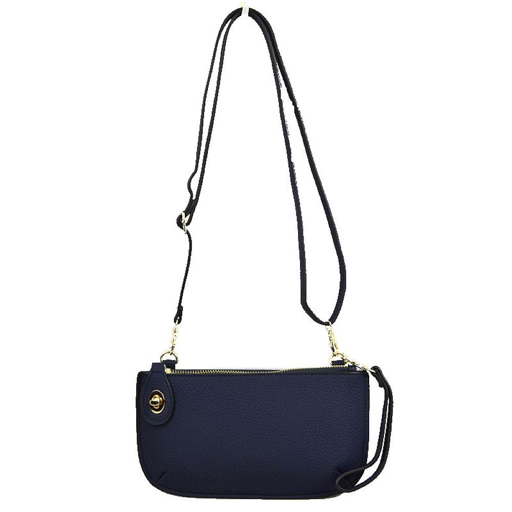 Navy Blue This versatile everyday bag features a compact pebbled textured body with a slightly curved base silhouette. Designed for organized daily or evening use, the main storage compartment is secured by a top zipper closure and accented with a small decorative metallic turn-lock detail on the side panel. It offers multiple carrying options, equipped with a long, adjustable crossbody shoulder strap and a shorter matching wristlet loop