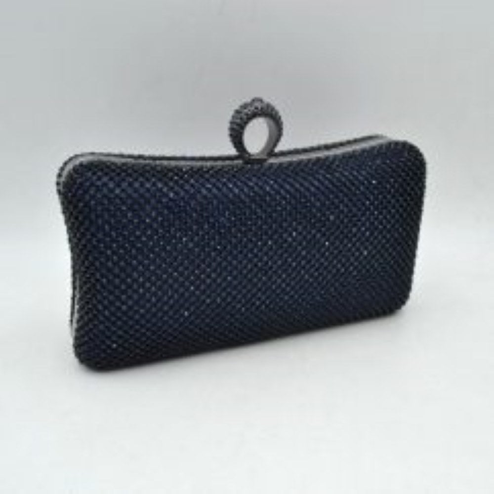 Navy-blue This hard-shell box clutch features a curved rectangular profile entirely covered in neat rows of small, shimmering circular embellishments for an elegant accent to everyday ensembles. A prominent, textured ring-style clasp sits centered at the top, serving as both a functional closure mechanism to access the interior storage compartment and an integrated finger-loop handle element for secure hand-held carrying.