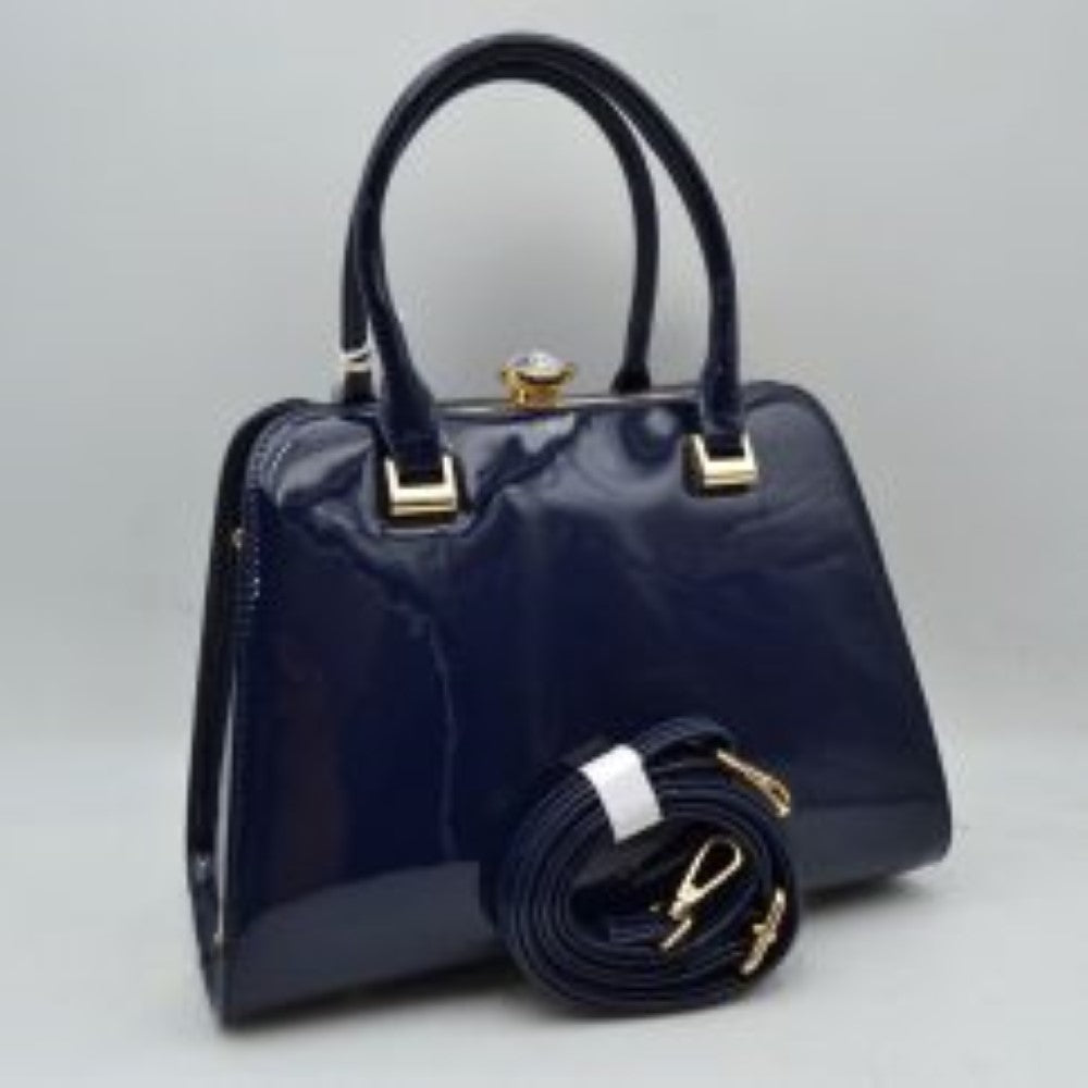 Navy blue This sophisticated frame handbag features a high-shine patent finish and a structured trapezoidal silhouette, making it an elegant choice for evening or formal wear. Designed with a classic frame top closure, it is secured by a distinctive pearl-accented gold-tone twist lock. Dual rolled top handles attached via polished metallic hardware allow for stylish handheld carrying, while an included detachable shoulder strap with gold-tone clasps offers versatile hands-free shoulder options.