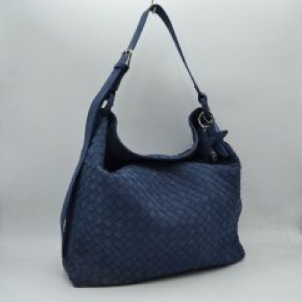 Navy-blue This slouchy hobo bag features a distinctive woven pattern across its exterior, offering a textured and modern look for everyday use. Designed with a spacious main compartment to easily accommodate daily essentials, the bag includes an adjustable flat shoulder strap secured with a metallic buckle for customizable carrying comfort. A decorative star-shaped charm is attached to the side via metallic hardware, adding a unique accent to the overall clean design.