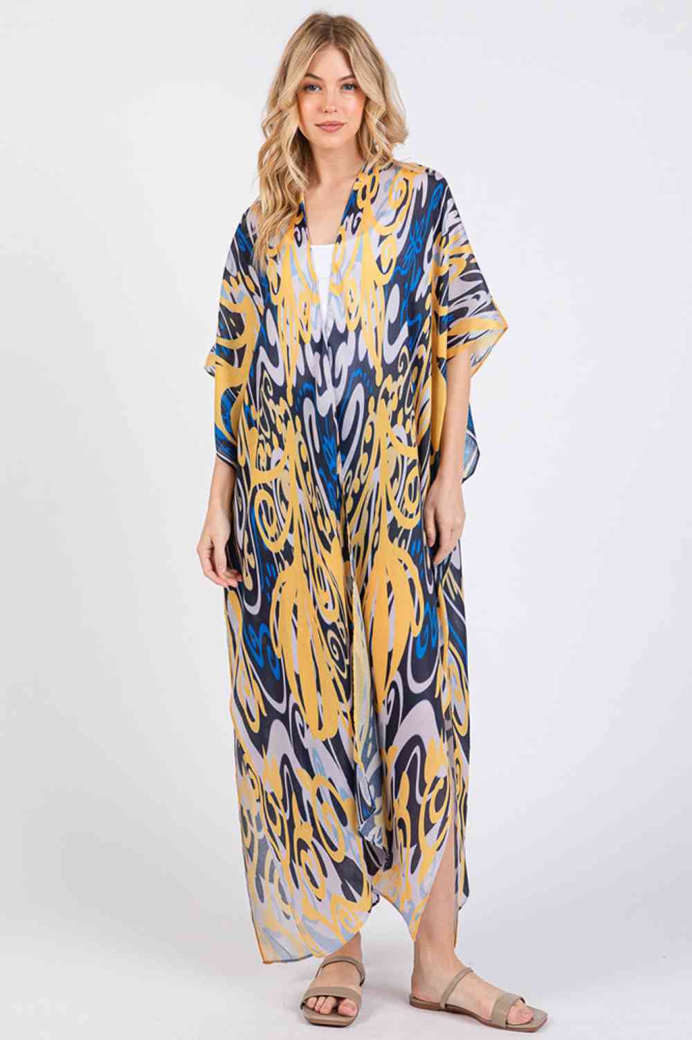 Navy Effortless bohemian elegance meets summer comfort in this open-front kimono cover-up. Crafted from lightweight 100% polyester, it drapes beautifully over swimwear or casual outfits with its relaxed, flowing silhouette. The boho-inspired print adds artistic flair to any beach day or resort look. Generously sized at 35" x 47.5", it offers easy layering and movement. Perfect for poolside, beach getaways, or breezy warm-weather styling.