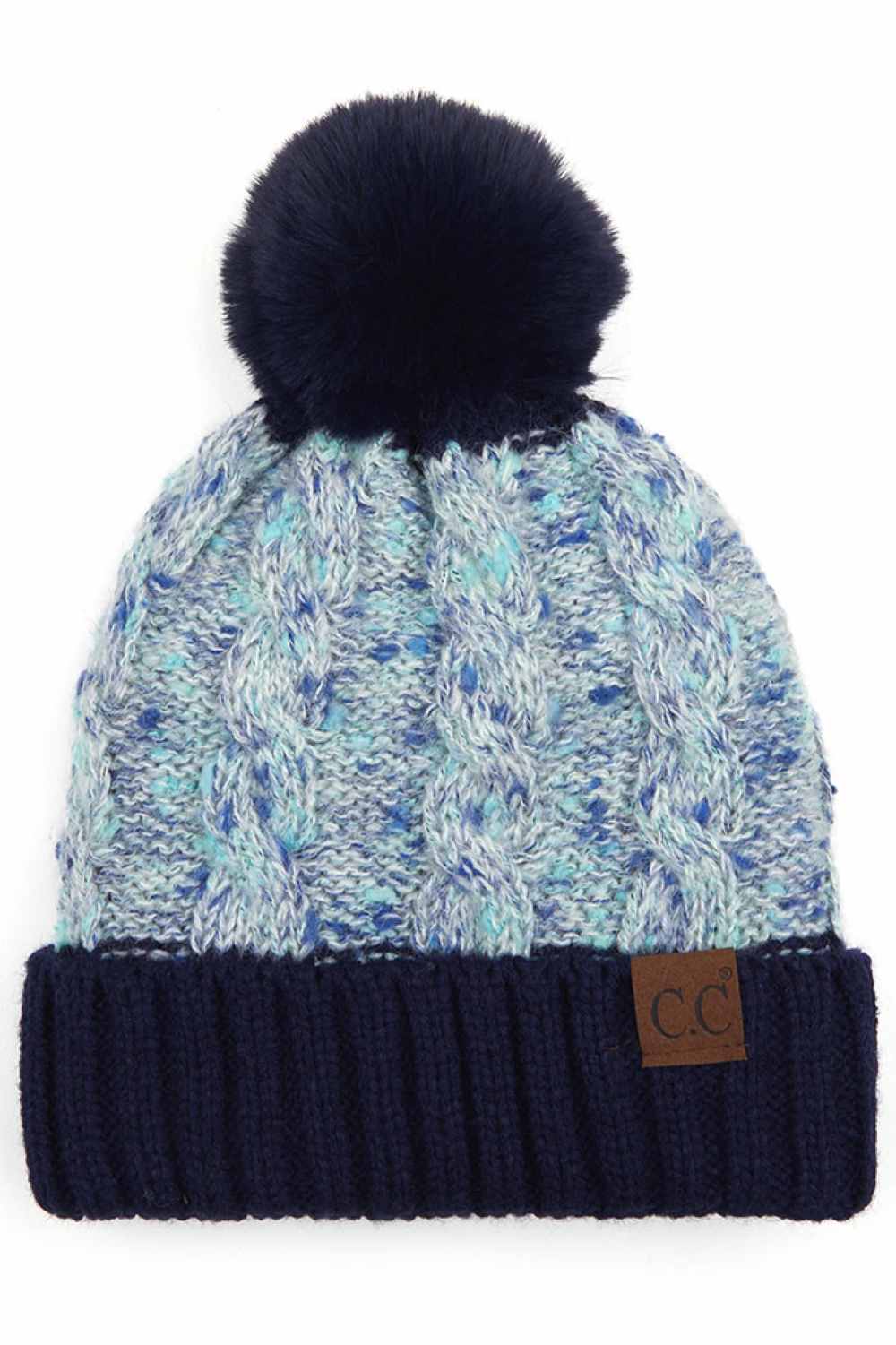 Navy The C.C Confetti Cable Knit Beanie with Pom features a textured cable-knit design accented with subtle confetti flecks for a fun, stylish winter look. Topped with a fluffy pom and crafted from soft, stretchy knit fabric, it delivers cozy warmth and all-day comfort in cold weather.