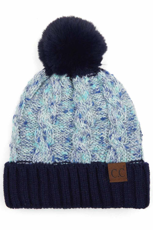 Navy The C.C Confetti Cable Knit Beanie with Pom features a textured cable-knit design accented with subtle confetti flecks for a fun, stylish winter look. Topped with a fluffy pom and crafted from soft, stretchy knit fabric, it delivers cozy warmth and all-day comfort in cold weather.