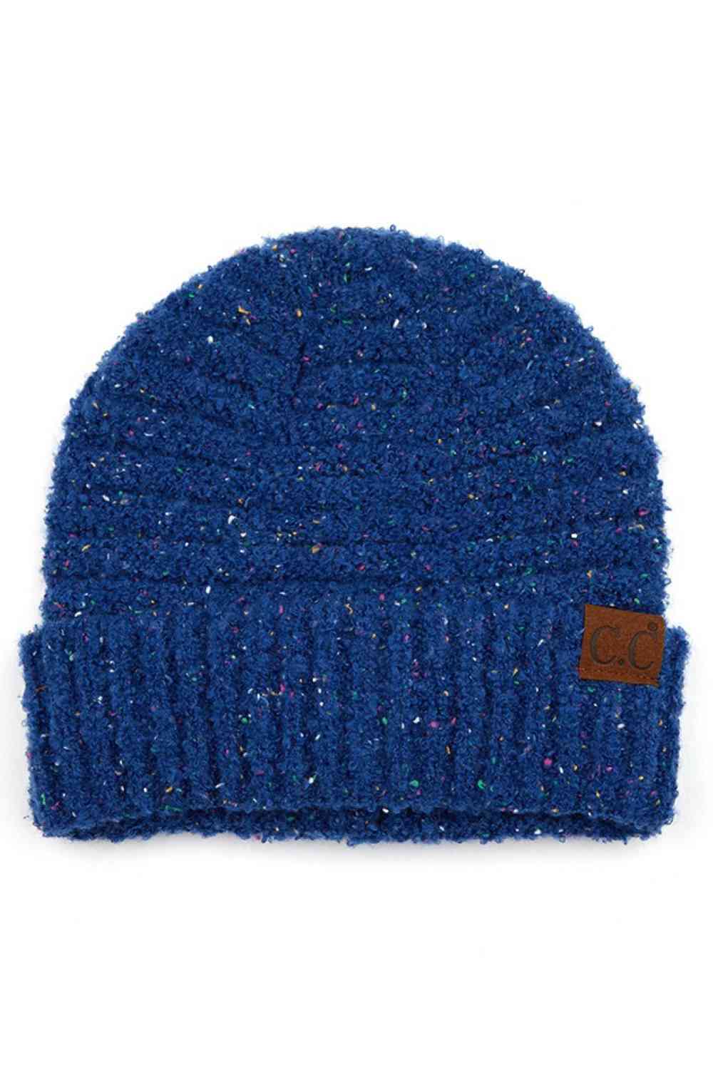 NAvy Elevate your winter wardrobe with this C.C Confetti Boucle Yarn Beanie, crafted from a premium blend of 95% polyester and 5% cotton. The textured boucle yarn creates visual interest and dimension, making it the perfect accessory to complement any outfit.