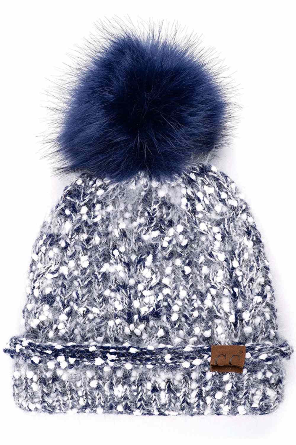 Navy The C.C Eyelash Confetti Yarn Knit Beanie with Pom features soft eyelash yarn blended with subtle confetti flecks for a fun, textured look. Topped with a fluffy pom-pom, it delivers cozy warmth and a playful sparkle perfect for cold-weather styling.
