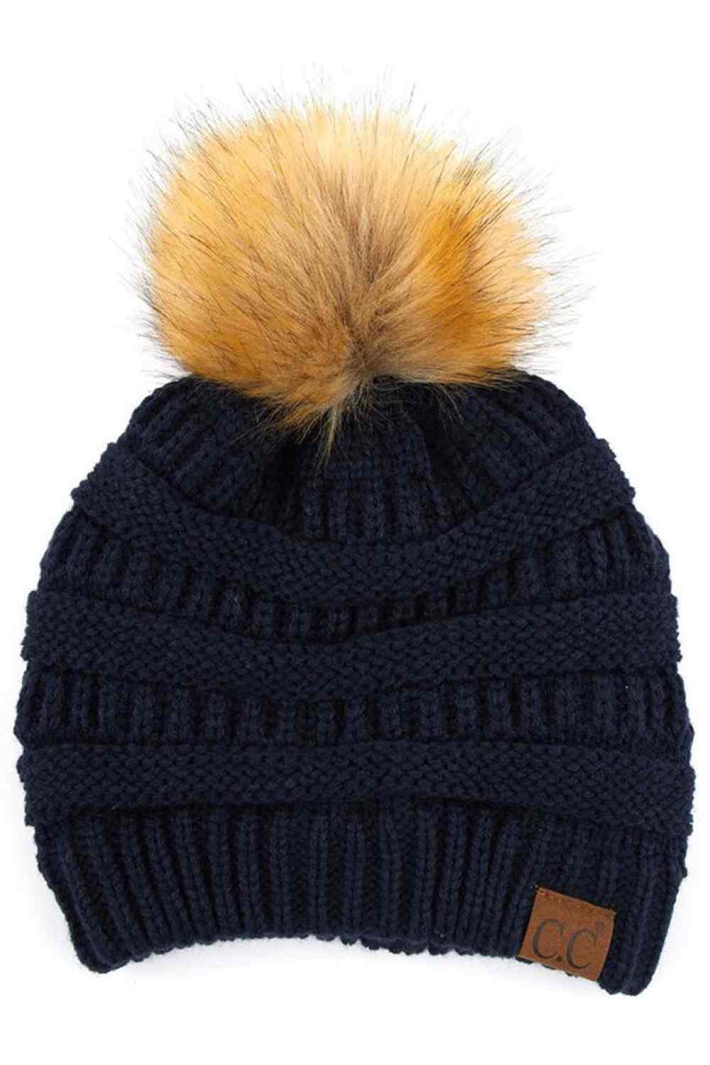 Navy Stay warm and cozy with this classic C.C Pom Pom Knit Beanie, crafted from 100% soft acrylic for all-day comfort. The ribbed knit design adds texture and durability, while the signature pom pom on top brings a playful touch to any winter outfit. One size fits most, making it the perfect accessory for everyone. Ideal for cold weather adventures or casual everyday wear.