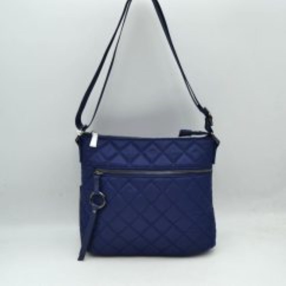 Navy This functional crossbody bag features a classic quilted diamond pattern exterior designed for effortless everyday use. It offers multiple storage compartments, including a main interior section accessed by a top zipper closure and a horizontal front zippered pocket accented by an attached circular ring pull tab. The bag is equipped with a matching flat shoulder strap connected by side loops, featuring an integrated adjustment buckle to easily customize the carrying length.