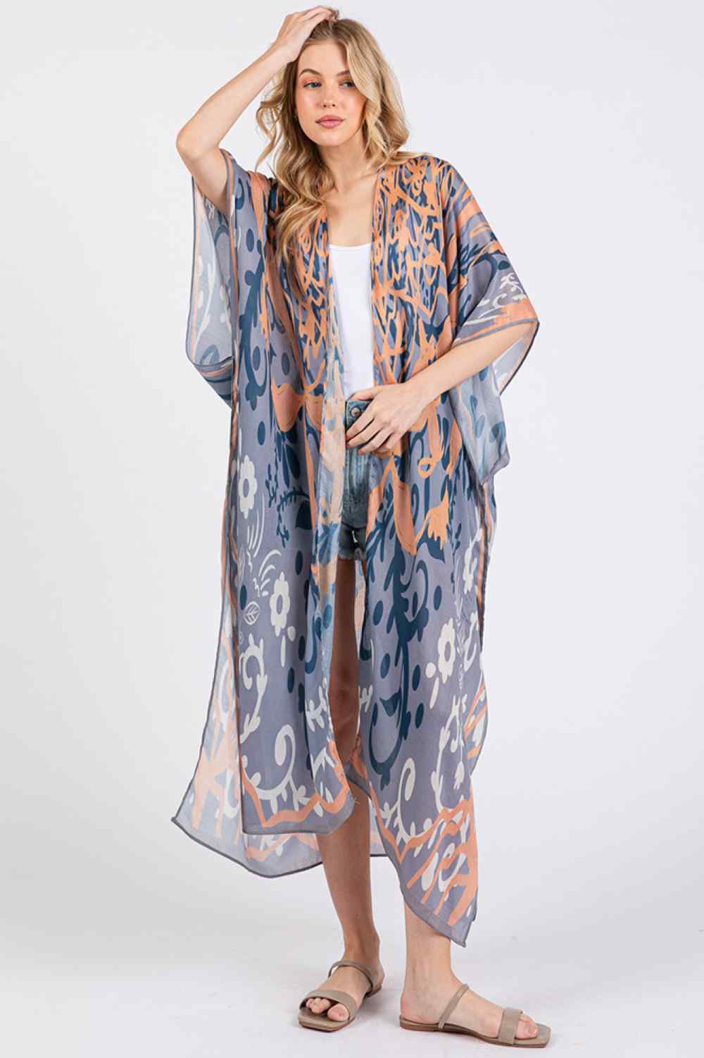 Navy Effortless bohemian elegance meets summer comfort in this open-front kimono cover-up. Crafted from lightweight 100% polyester, it drapes beautifully over swimwear or casual outfits with its relaxed, flowing silhouette. The boho-inspired print adds artistic flair to any beach day or resort look. Generously sized at 35" x 47.5", it offers easy layering and movement. Perfect for poolside, beach getaways, or breezy warm-weather styling.
