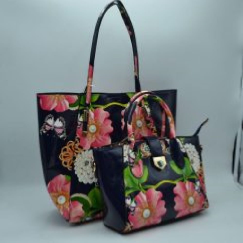 Navy blue This coordinates bag set features a vibrant, eye-catching design with large pink blossoms, white floral clusters, and delicate butterflies printed over a glossy patent faux-leather finish in a deep navy blue. The set includes a spacious, open-top tote bag equipped with slim, comfortable double shoulder straps—perfect for carrying larger daily essentials. It is paired with a matching structured satchel that features dual rolled top handles
