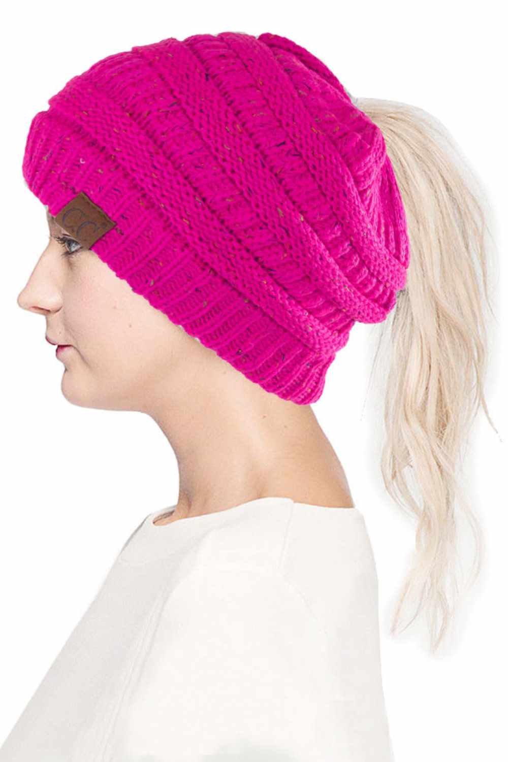 Pink The C.C Confetti Ponytail Messy Bun Beanie features a soft knit design with subtle confetti flecks for a fun, playful look. Designed with a convenient opening for ponytails or messy buns, it keeps you warm while allowing you to style your hair comfortably.