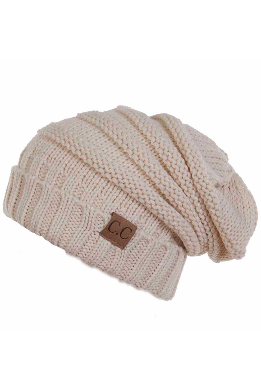 New Beige Wrap yourself in warmth with this C.C Slouchy Knitted Beanie, crafted from 100% soft acrylic for ultimate comfort. The oversized silhouette and plush pom pom detail create a relaxed, on-trend look perfect for chilly days. Available in nine versatile colors—Beige, Berry, Dark Denim, Heather Gray, Ivory, Pistachio, Rose, Steel Blue, and Violet Purple—this beanie pairs effortlessly with any winter wardrobe. The ribbed knit construction ensures durability and a flattering fit.