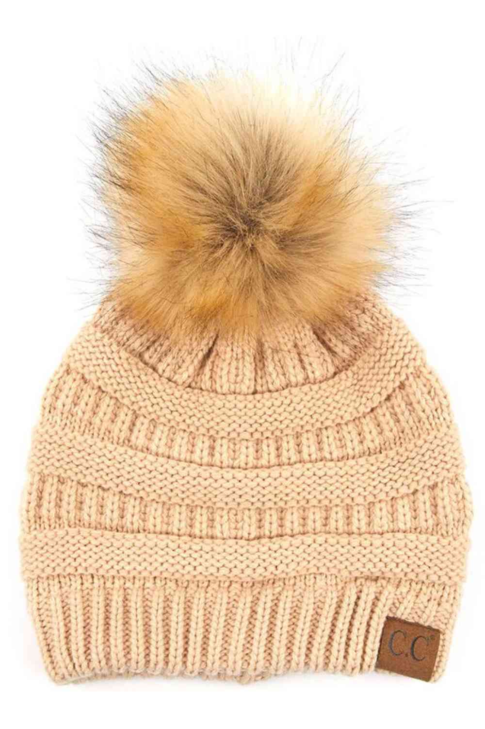 New Beige Stay warm and cozy with this classic C.C Pom Pom Knit Beanie, crafted from 100% soft acrylic for all-day comfort. The ribbed knit design adds texture and durability, while the signature pom pom on top brings a playful touch to any winter outfit. One size fits most, making it the perfect accessory for everyone. Ideal for cold weather adventures or casual everyday wear.