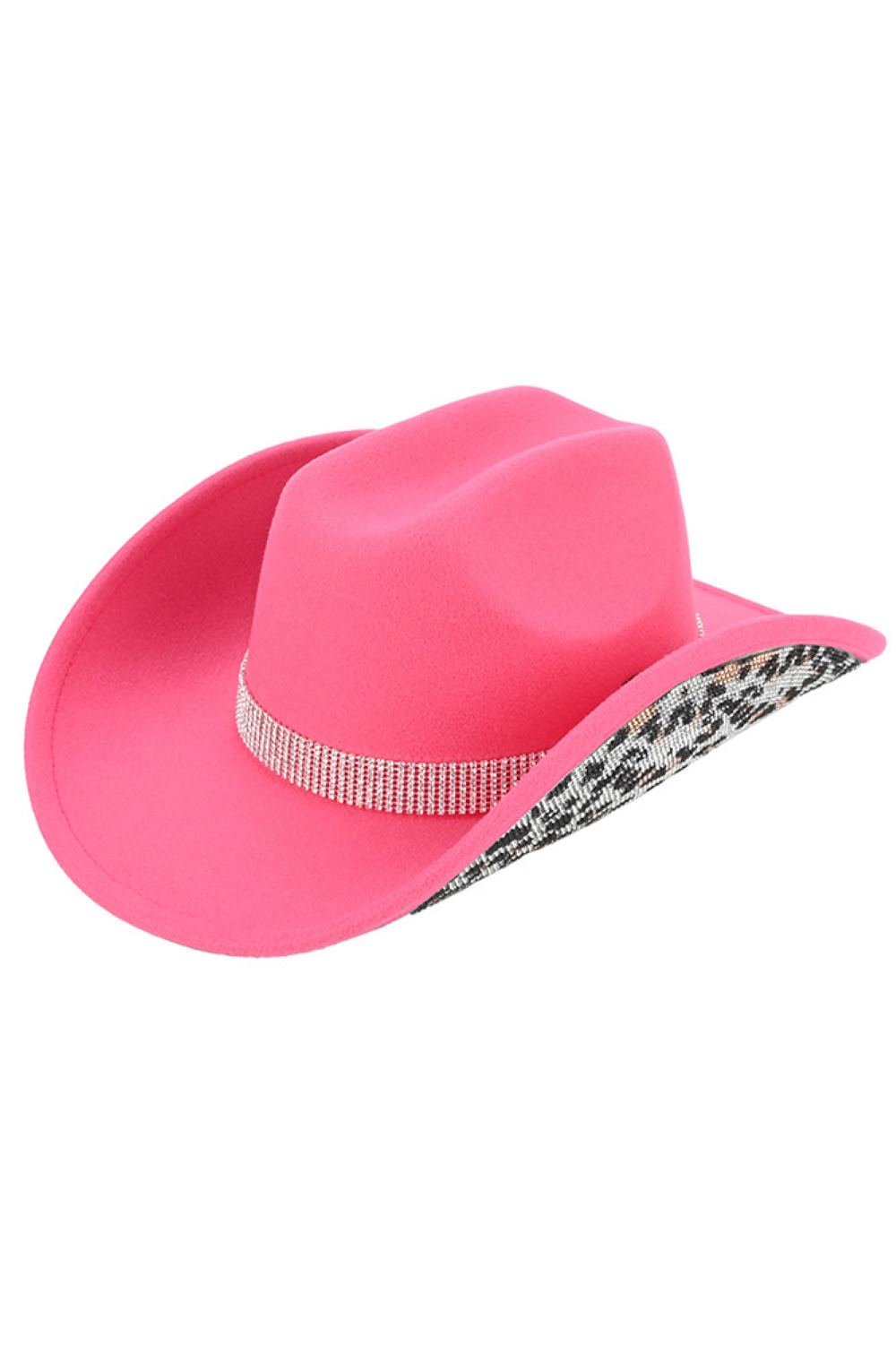 New Candy Pink Make a statement with this C.C Leopard Pattern Rhinestone Cowboy Hat, where bold animal print meets sparkling embellishment. Constructed from 100% polyester vegan felt, this hat offers a soft, suede-like texture with lasting durability. The rhinestone accents add glamorous detail perfect for Western-inspired outfits, festivals, or standout everyday style. With a 3.5" brim and 5" crown, it's designed for a comfortable fit. One size fits most with a 22.63" circumference. Made in China.